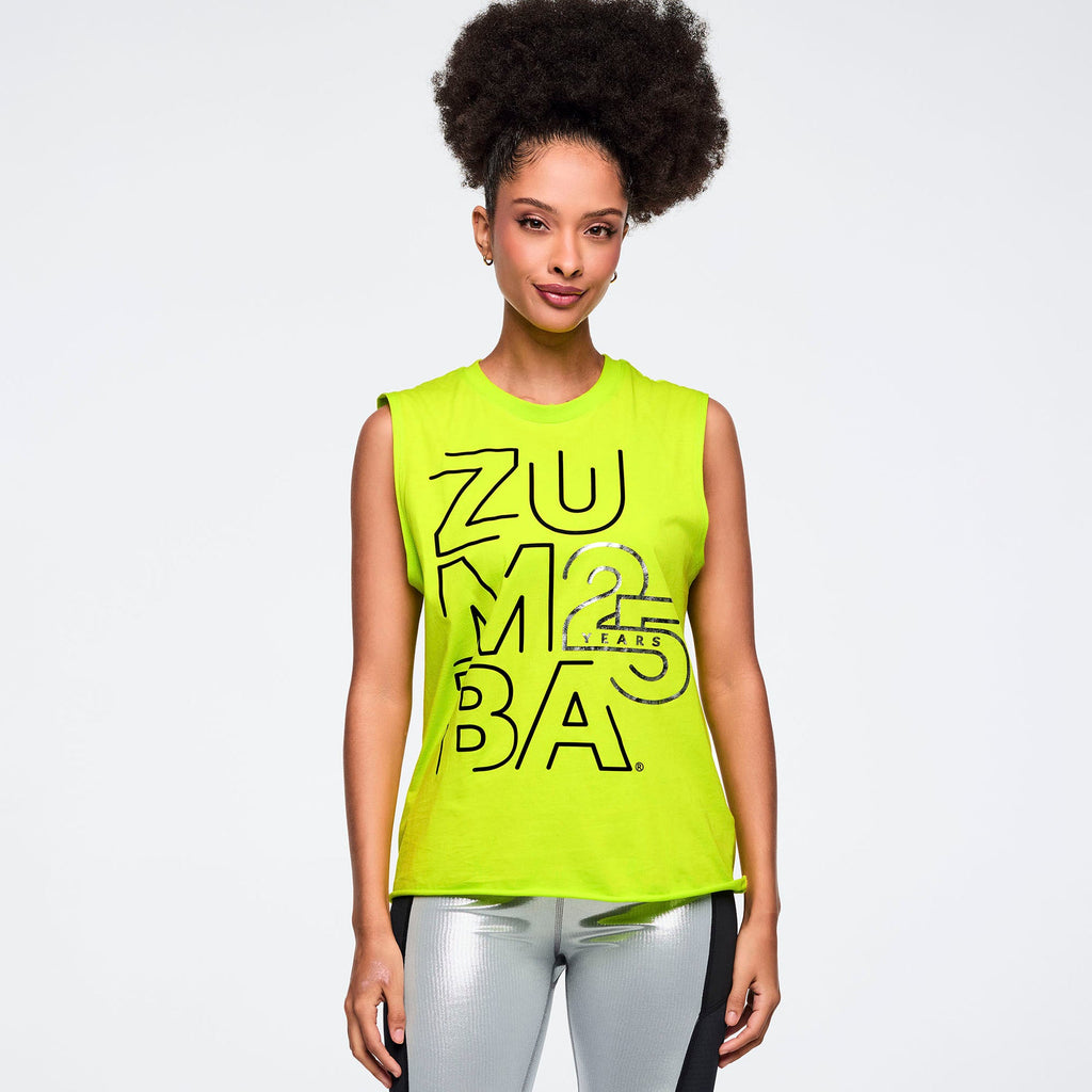 Woman wearing a bright green Zumba tank top on a plain background